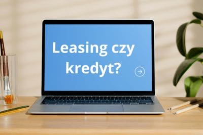 Laptop z napisem "Leasing czy kredyt?" – porównanie form finansowania